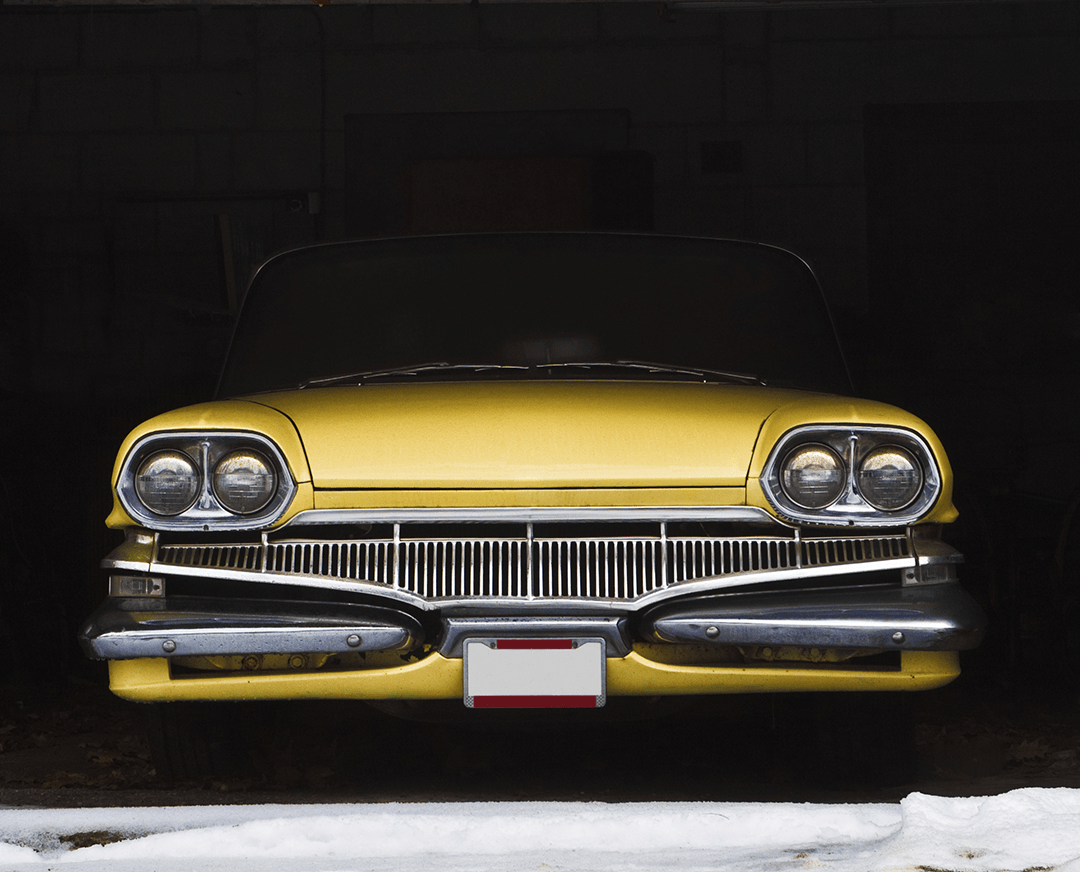 yellow classic vehicle in storage for the winter
